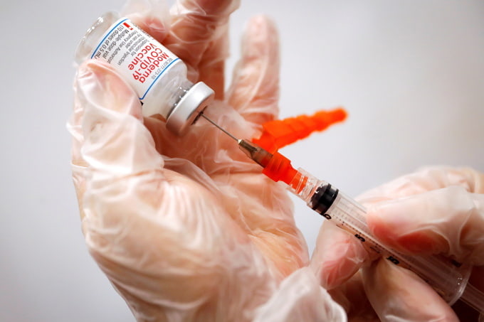 Nhân viên y tế chuẩn bị một liều vaccine Covid-19 tại một điểm tiêm chủng lưu động ở New York, tháng 1/2020. Ảnh: Reuters